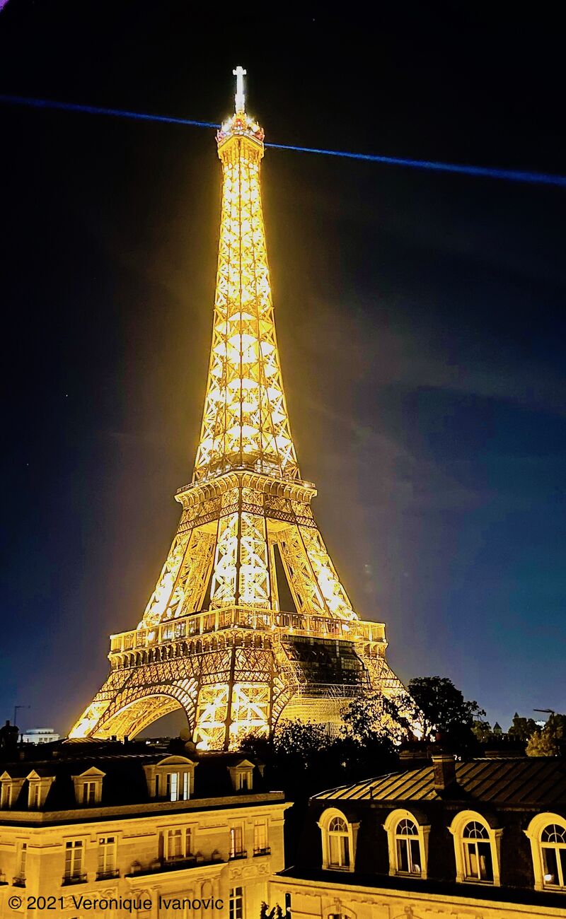 Like a glowing Diamond in the Sky, the once most controversial project in Paris, the Eiffel Tower with the wonderful landscape of traditional Parisian roof tops in fore front